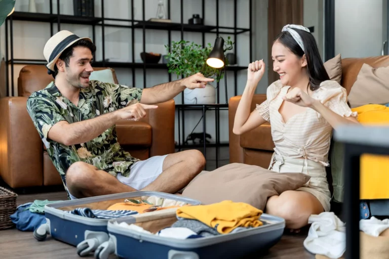 happy-couple-asian-caucasian-marry-lover-wear-casual-cloth-enjoy-packing-cloth-travel-stuff-luggage-floor-living-room-lover-couple-singing-funny-dance-together-home